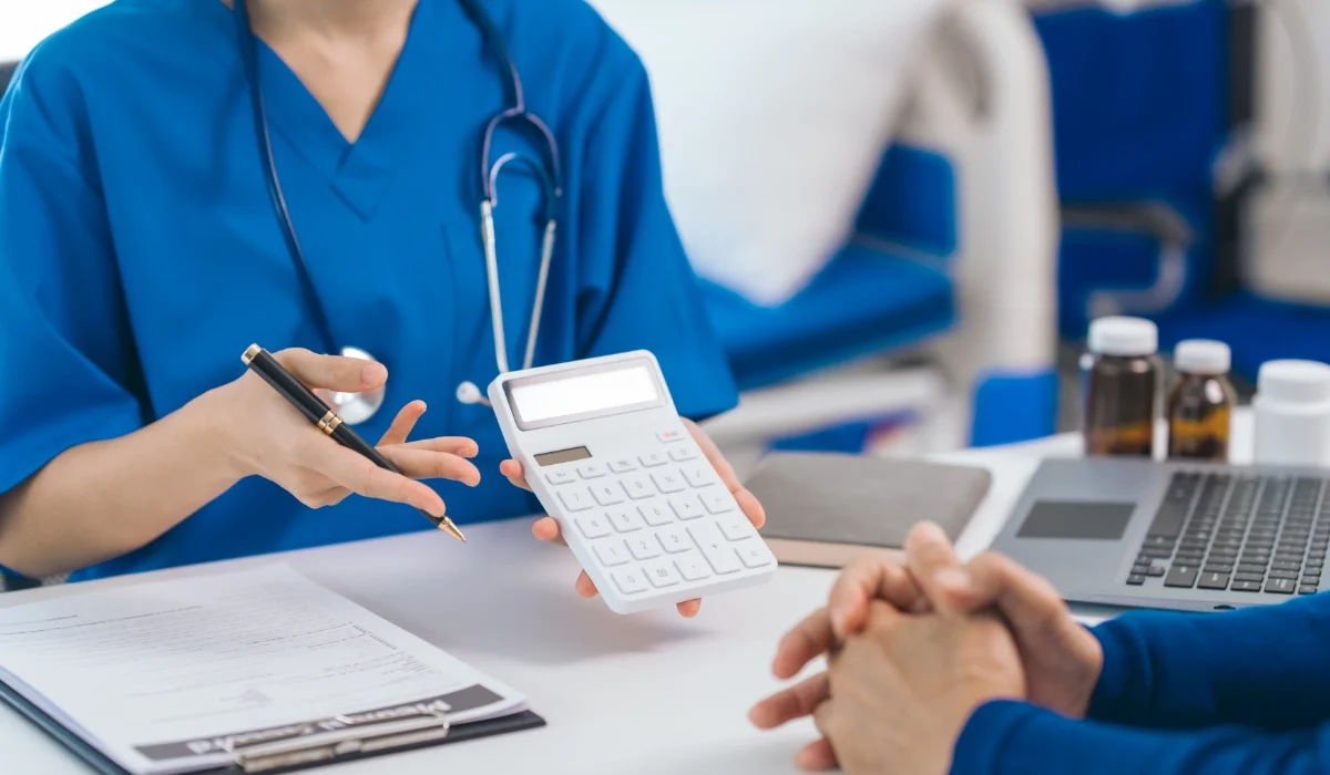 Doctor explaining Upper GI Endoscopy and Colonoscopy costs to a patient during a medical consultation.
