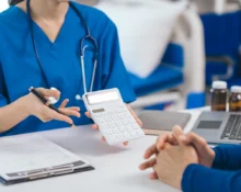 Doctor explaining Upper GI Endoscopy and Colonoscopy costs to a patient during a medical consultation.