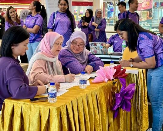 Dr. Renee Tan Psychiatrist in Malaysia participating in a community outreach event with colleagues.