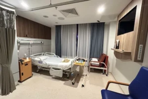Patients room with TV and chairs around