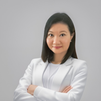 Dr. Renee Tan, psychiatrist in Malaysia, wearing a white blazer with a confident expression.