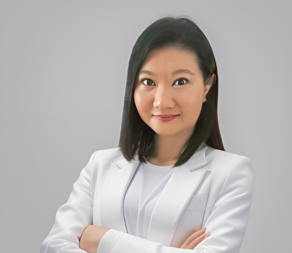 Dr. Renee Tan, psychiatrist in Malaysia, wearing a white blazer with a confident expression.