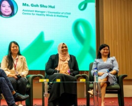 Dr. Renee Tan Psychiatrist in Malaysia speaking at a mental health panel discussion.