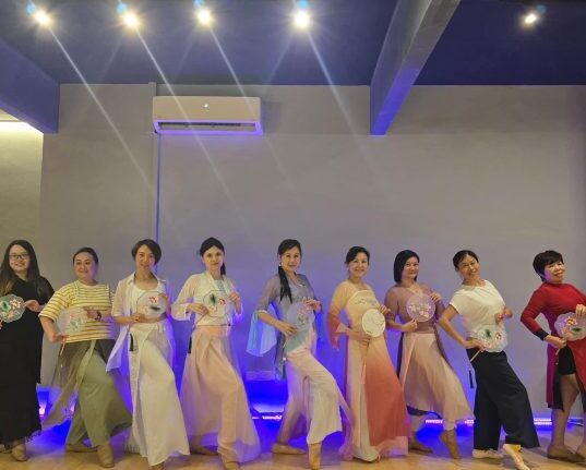 Dr. Renee Tan Psychiatrist in Malaysia engaging in a cultural dance activity for mental wellness.