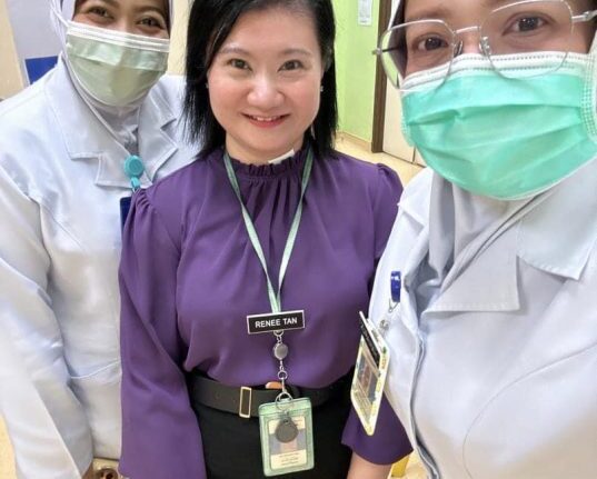 Dr. Renee Tan Psychiatrist in Malaysia with healthcare professionals at a hospital.