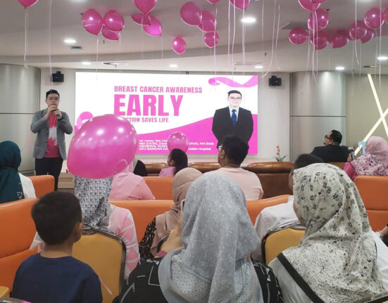 A community health event featuring a doctor educating an audience about disease prevention.