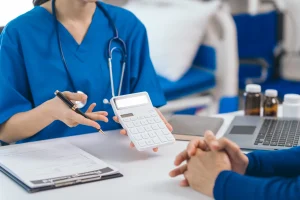 Doctor explaining Upper GI Endoscopy and Colonoscopy costs to a patient during a medical consultation.
